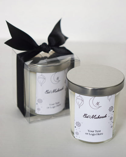 Two candles with 'Eid Mubarak' labels on a white background Candles