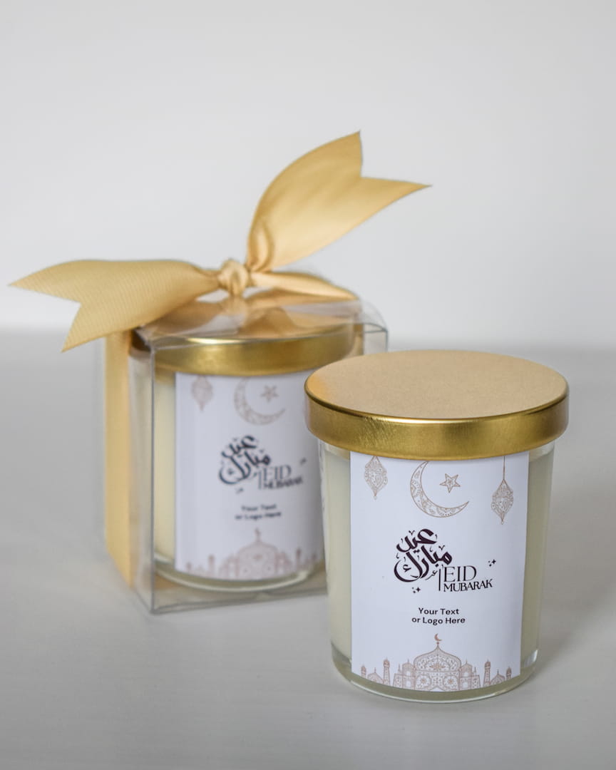 Two Personalized Eid Mubarak Gifts Favors Scented Candle gold lids and decorative labels on a white background
